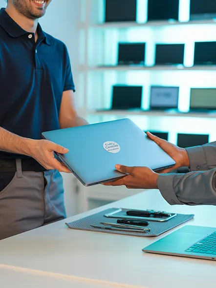 man giving laptop to customer image
